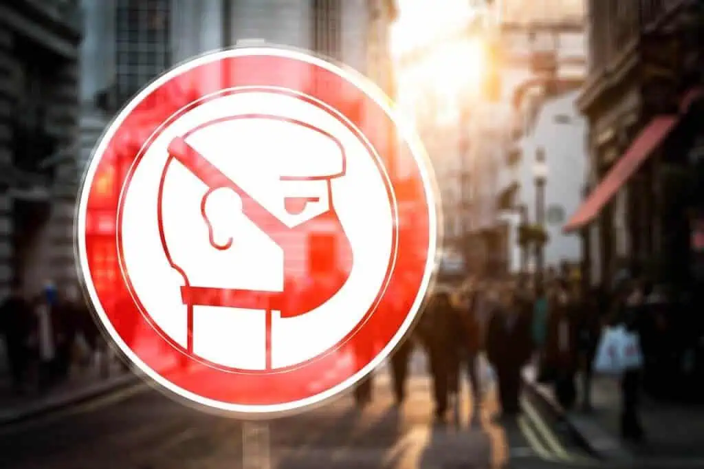 sign showing person wearing face mask against city background